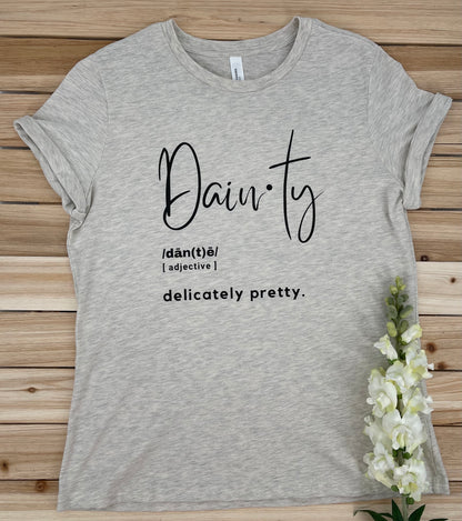 beige crew neck graphic tee that has the definition of dainty on it