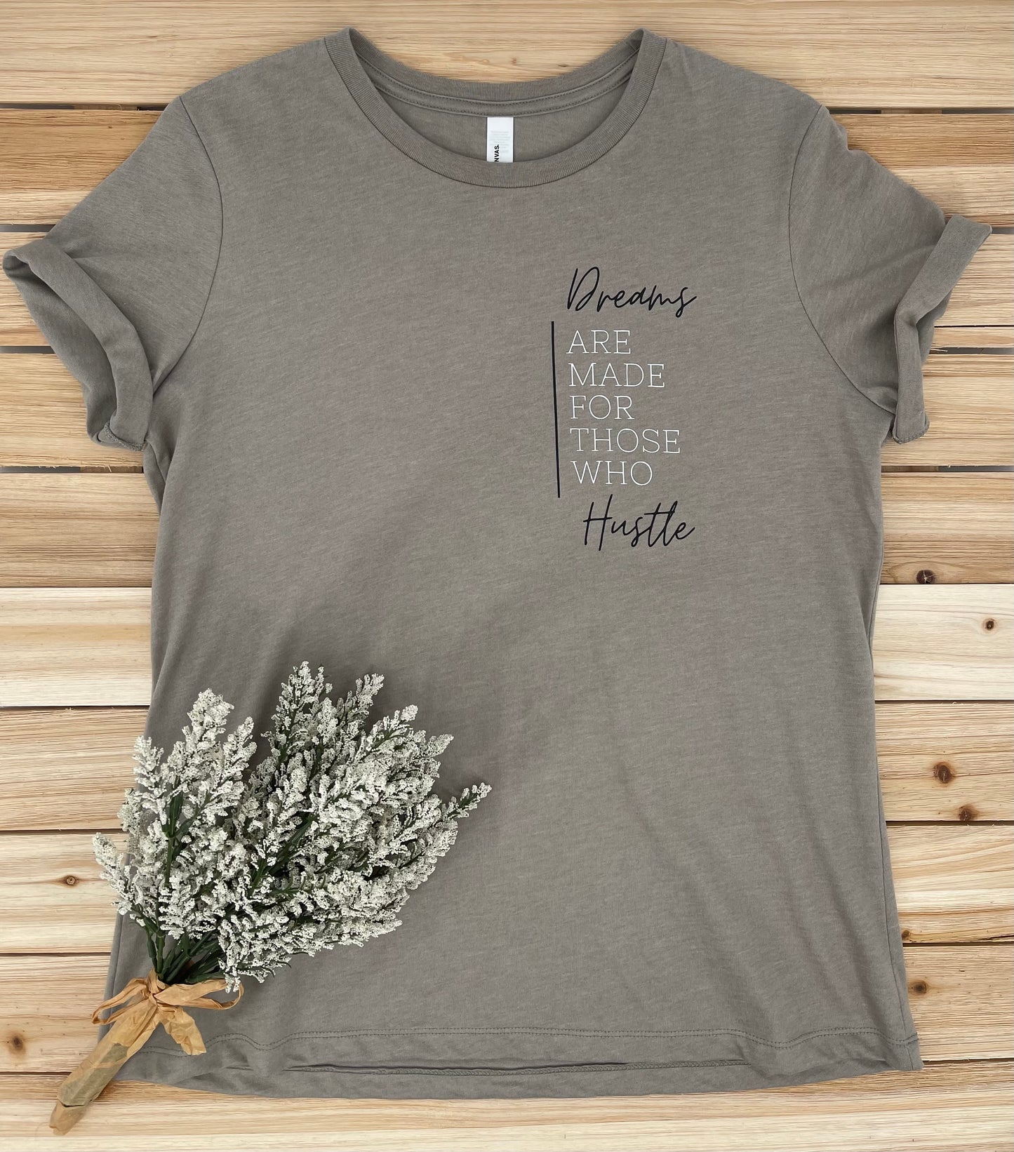 shirt with inspirational statement on it laying on a wood board